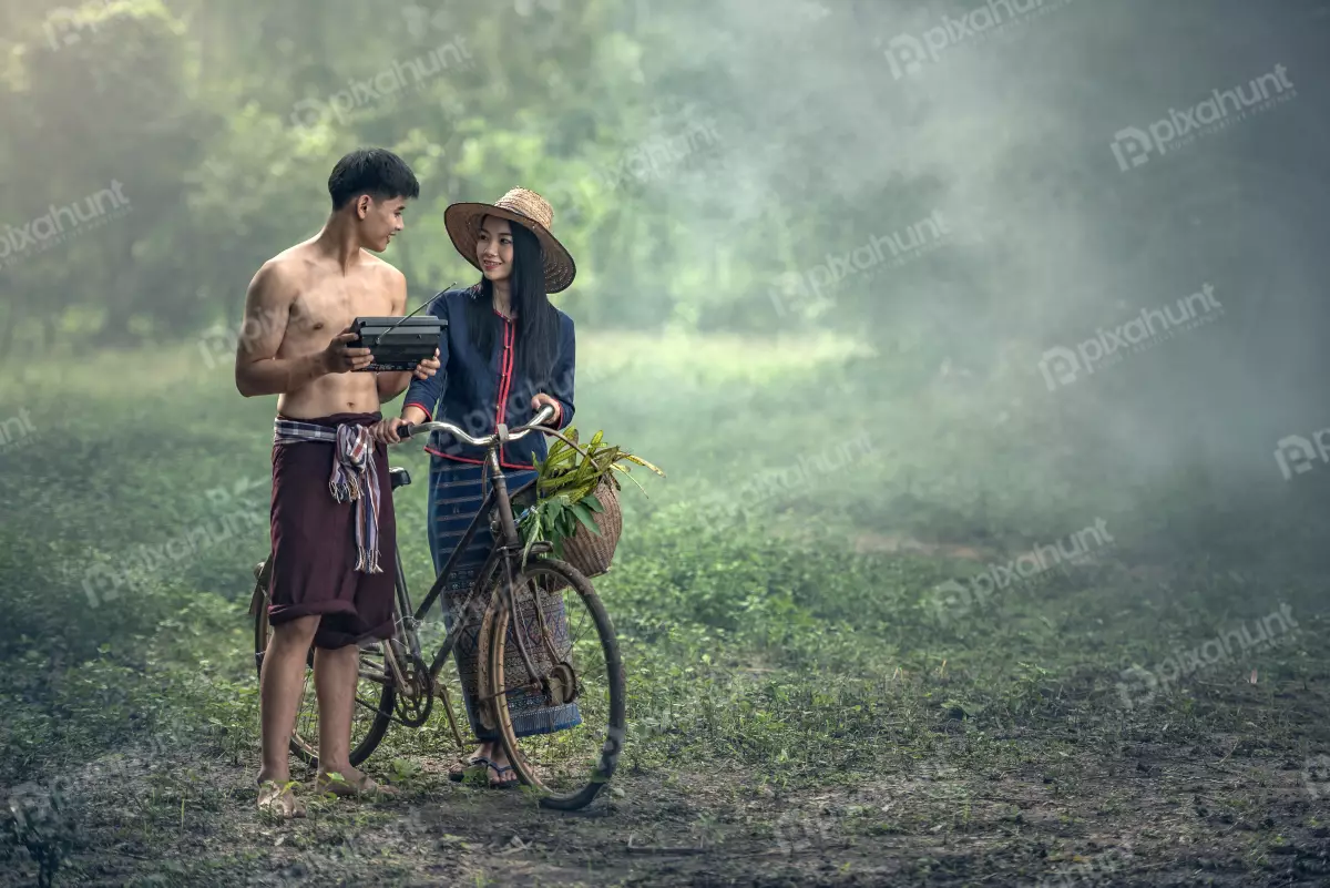 Free Premium Stock Photos A beautiful landscape of a rural area and a couple standing in the middle of a field