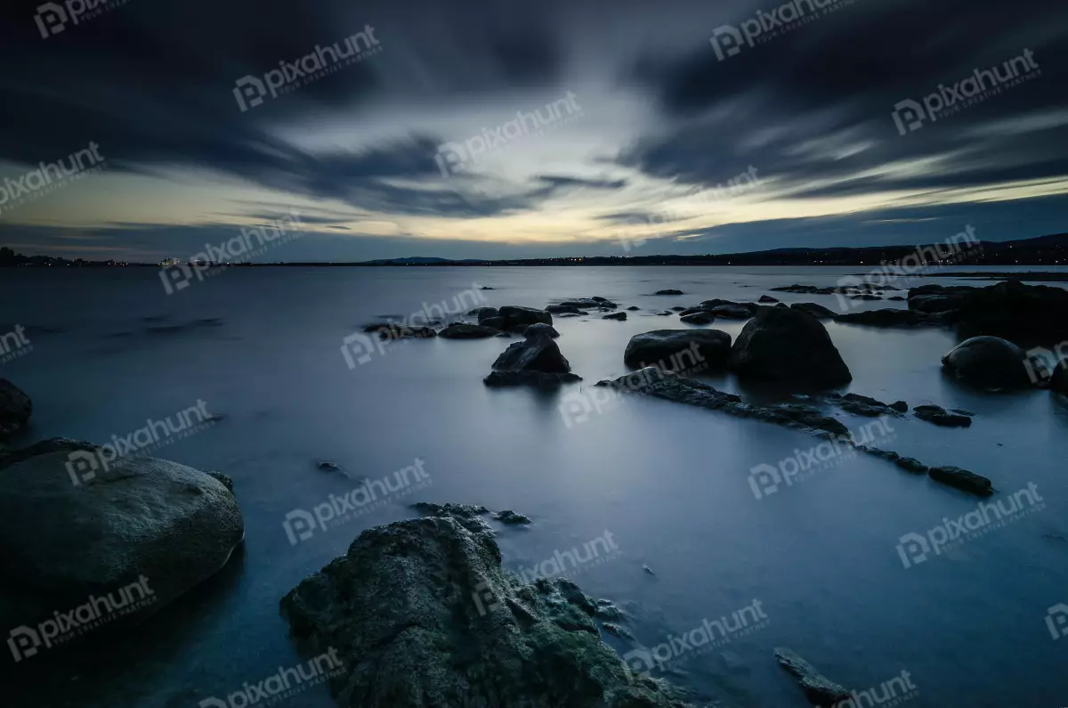 Free Premium Stock Photos A body of water is calm and still and the sky is dark and cloudy