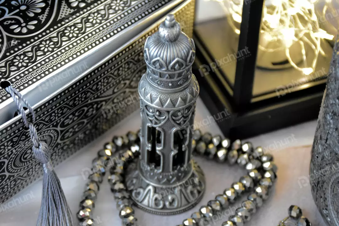Free Premium Stock Photos A bottle of perfume with a silver cap and intricate silver detailing