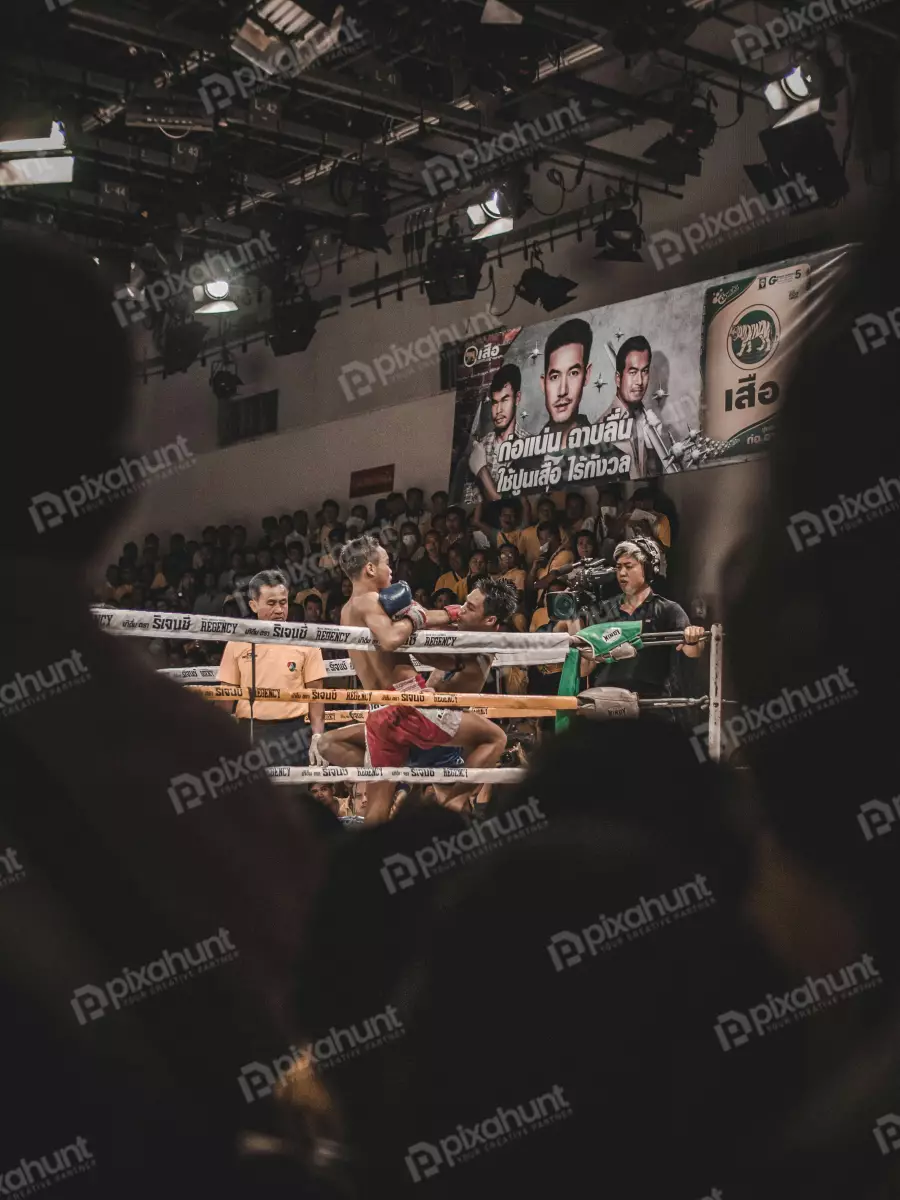 Free Premium Stock Photos A boxing match on two boxers are in the ring and the referee is standing in between them