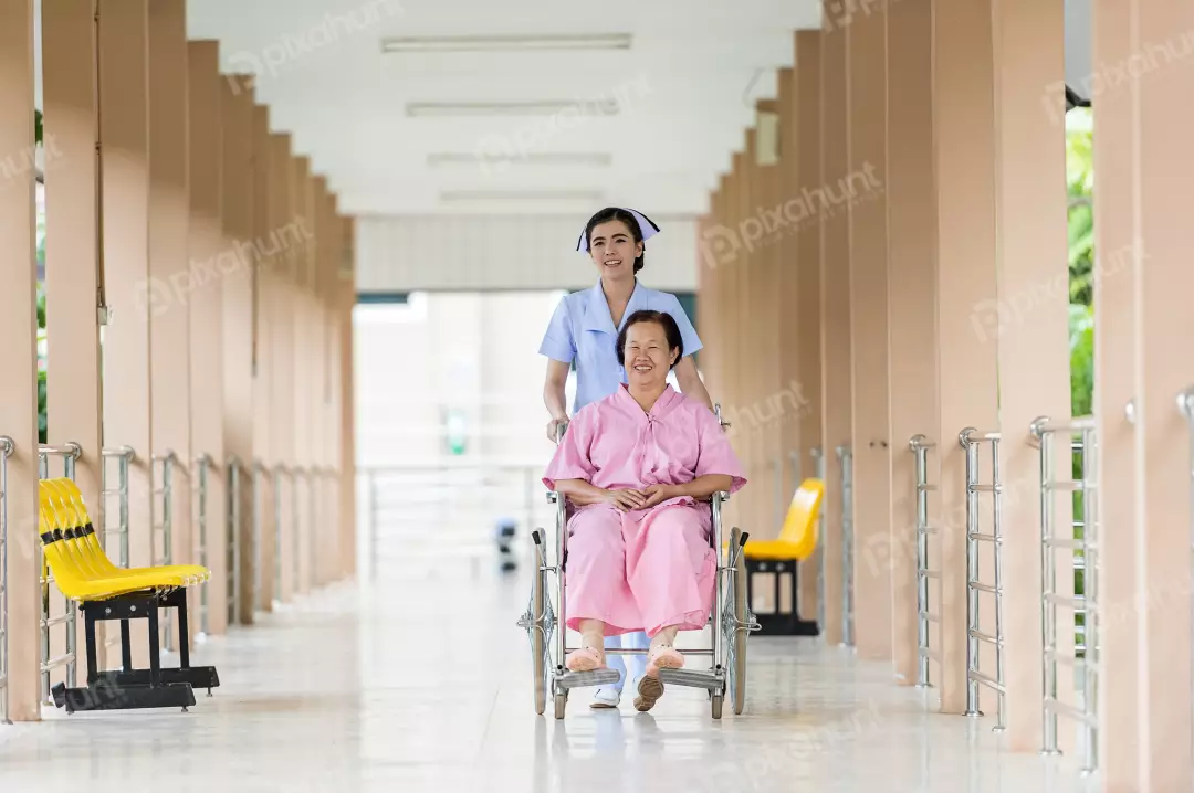 Free Premium Stock Photos A nurse pushing a patient in a wheelchair