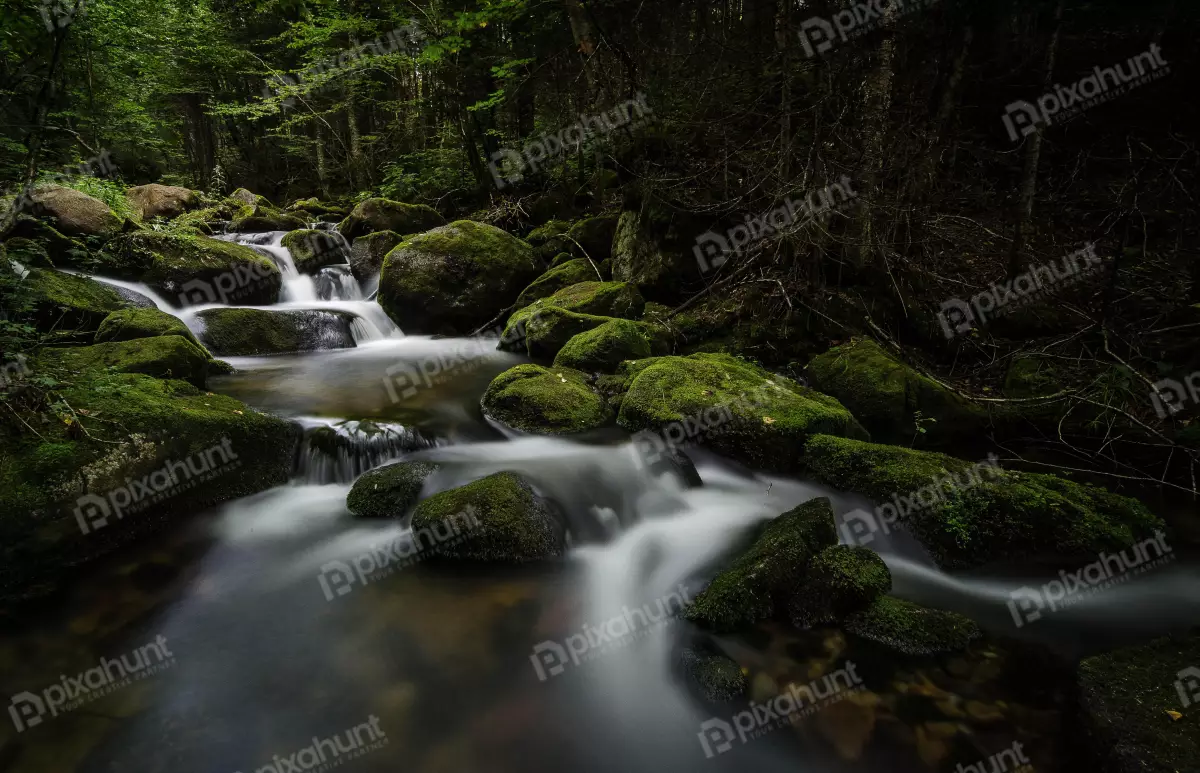 Free Premium Stock Photos a small waterfall water is rushing over the rocks creating a white blur