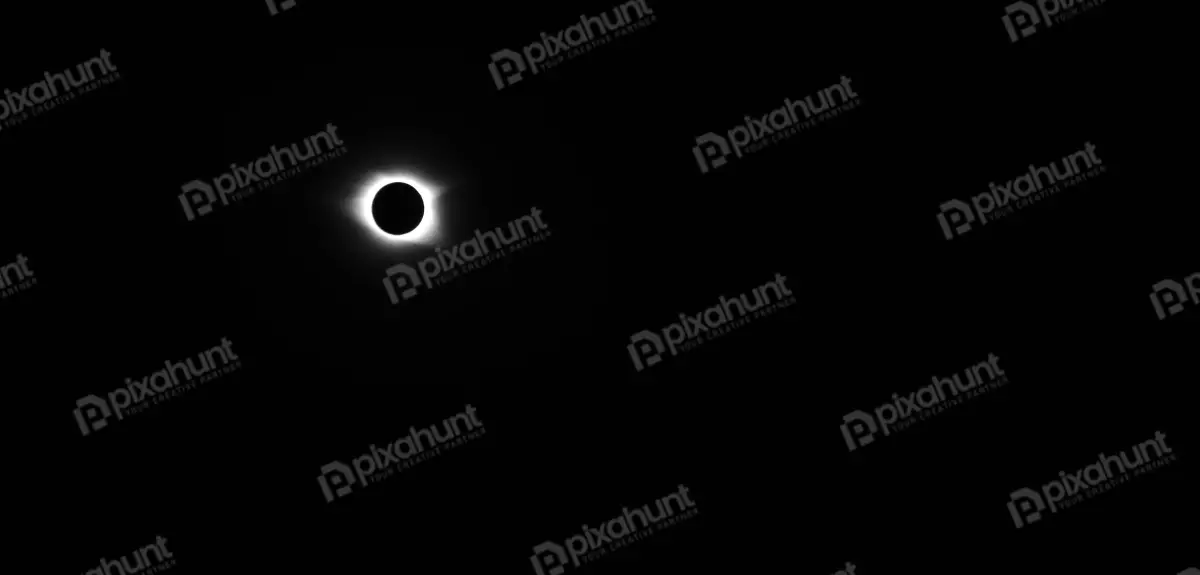 Free Premium Stock Photos A total solar eclipse Sun is completely covered by the Moon and the Sun's corona is visible around the edges of the Moon