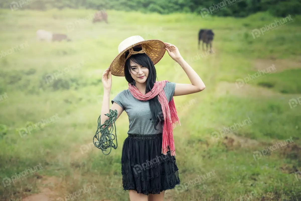 Free Premium Stock Photos A woman standing in a field and wearing a traditional Vietnamese hat and a colorful scarf with roof