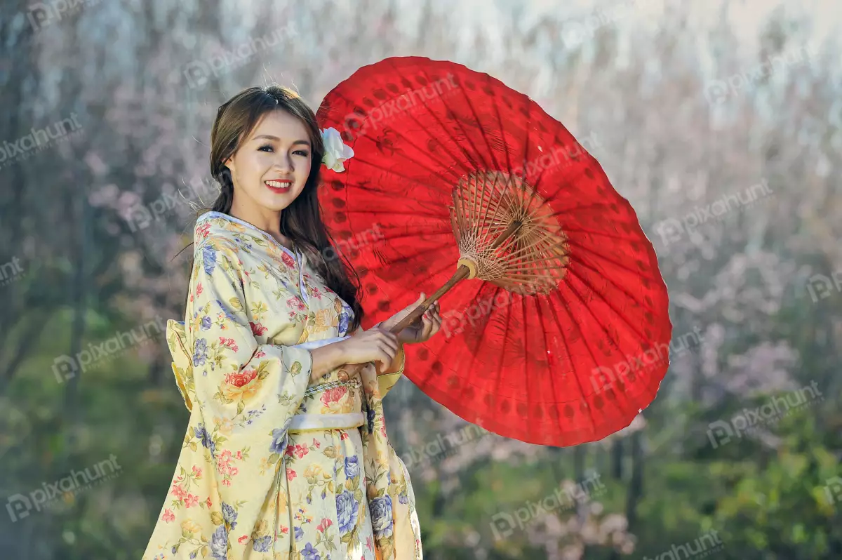 Free Premium Stock Photos A woman wearing a traditional Japanese kimono and dark hair is left out also she is holding a red umbrella