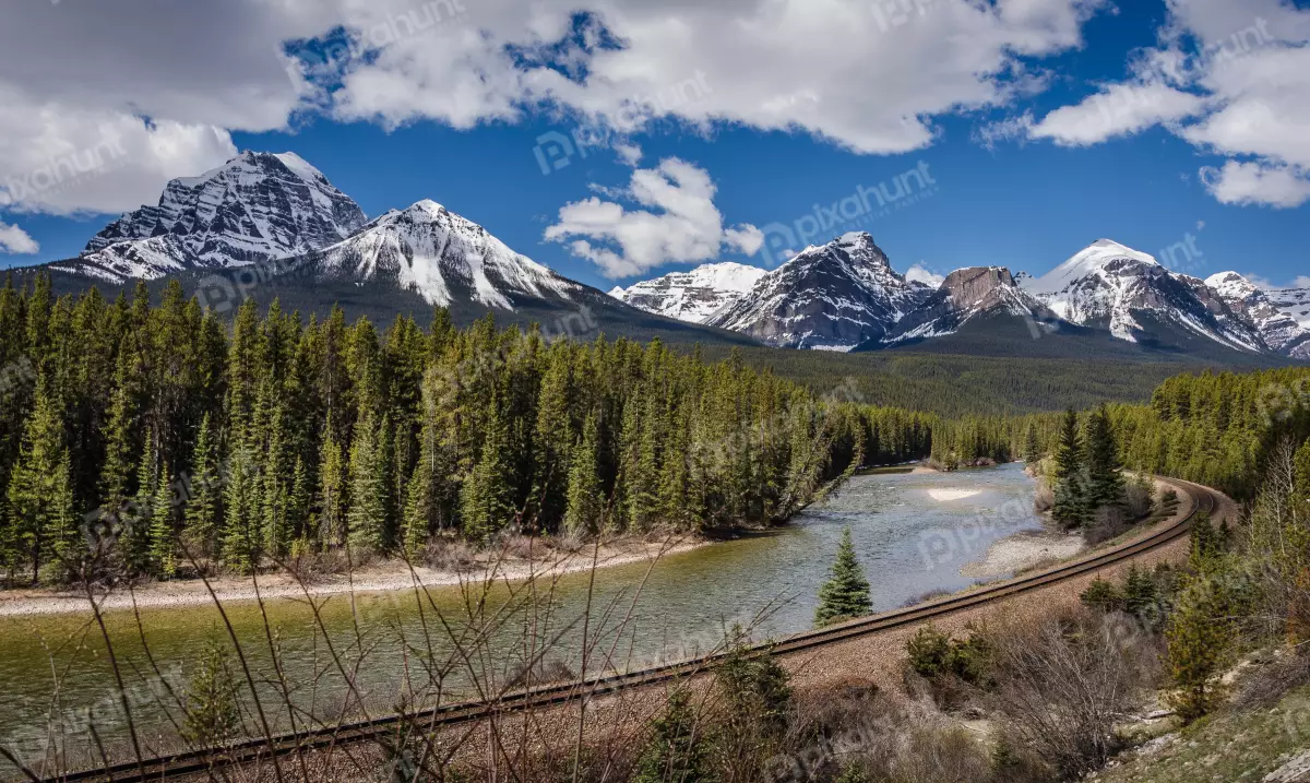 Free Premium Stock Photos beautiful landscape of the Canadian Rockies mountains are covered in snow and the river is a beautiful blue color
