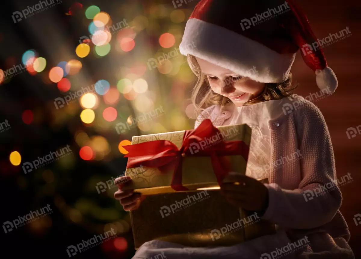 Free Premium Stock Photos Little girl looking at open box with christmas present