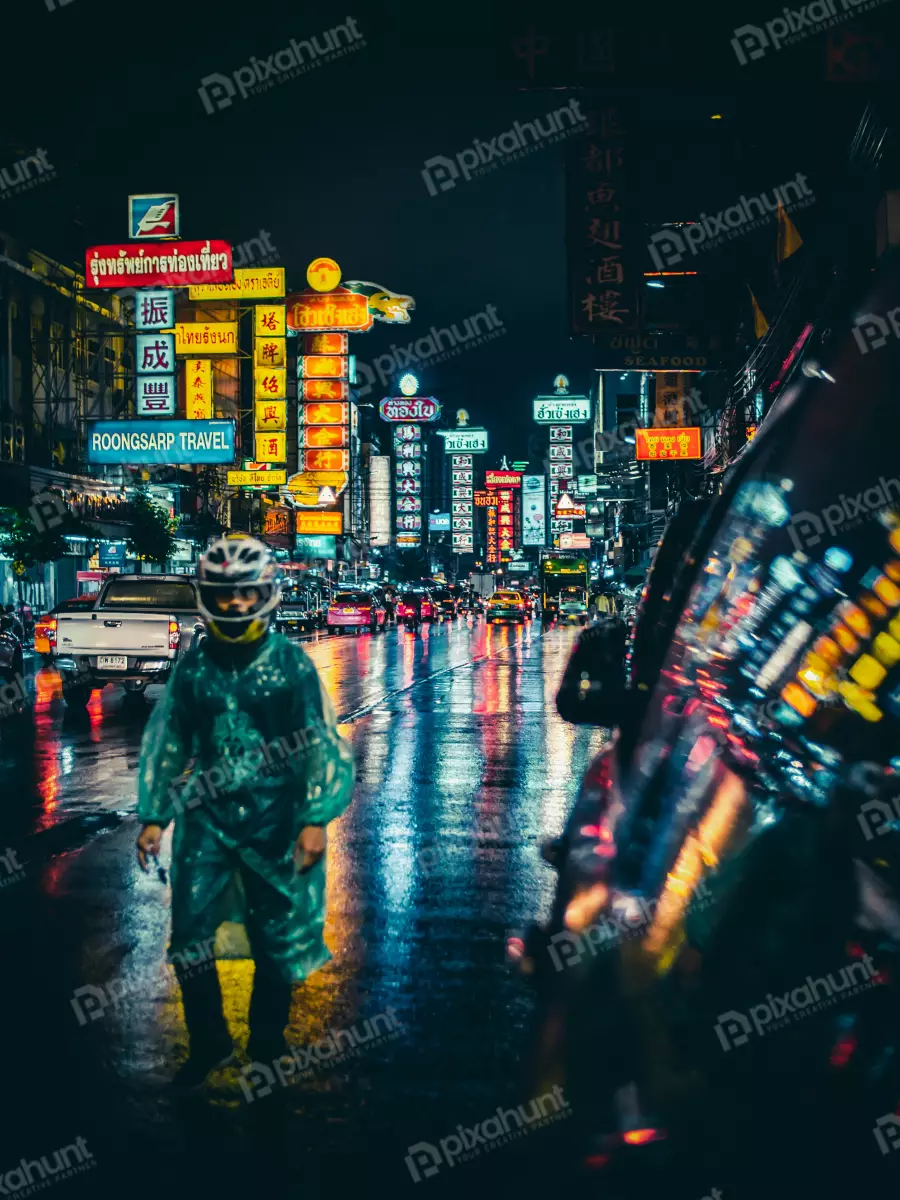 Free Premium Stock Photos Man in Green Raincoat and White Full-face Helmet Standing in Middle of Wet Street