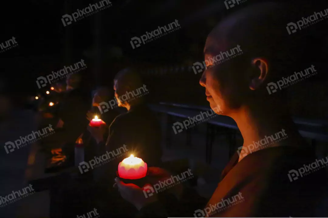 Free Premium Stock Photos Meny young Buddhist nun holding a candle in her hands