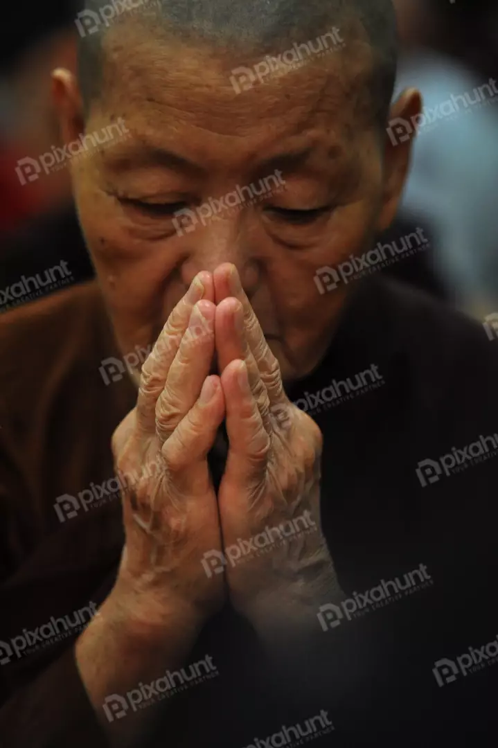 Free Premium Stock Photos Monk praying to god on gray black background with people stock image stock photo