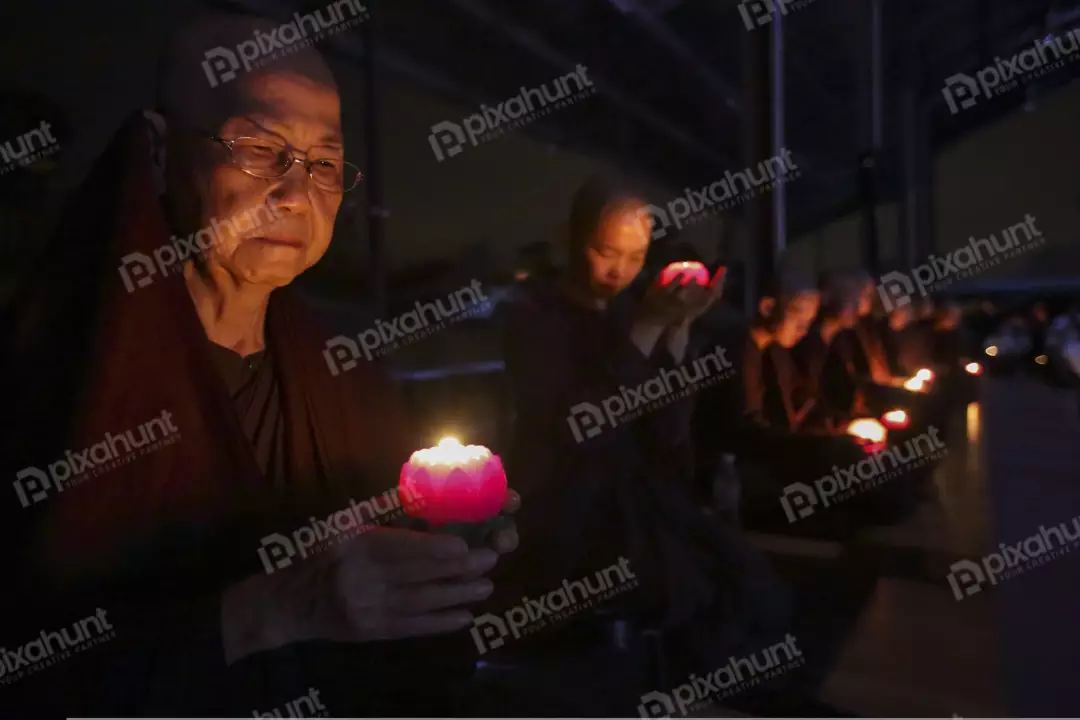 Free Premium Stock Photos Monks holding candle in a dark room