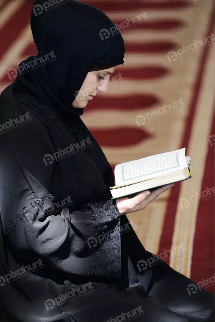 Free Premium Stock Photos Muslim Arabic Woman Sitting And Reading Holy Koran very carefully