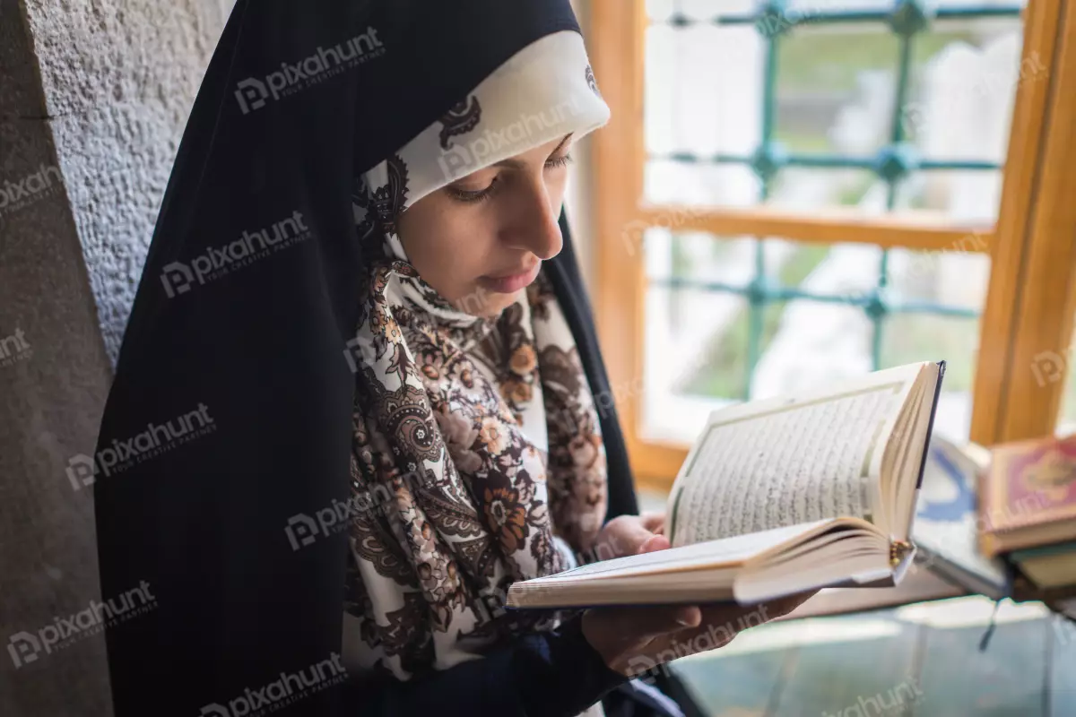 Free Premium Stock Photos Reading a book near a window. Unfortunately the person face is not visible due to blurring