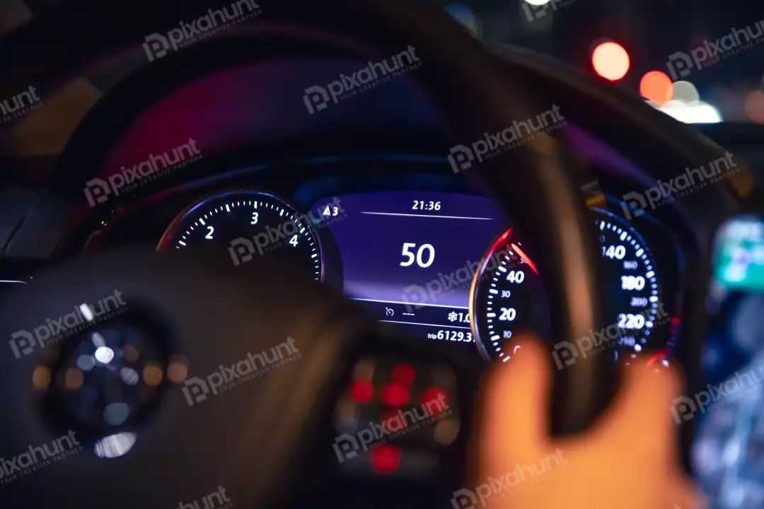 Free Premium Stock Photos Speed indication and womens hands on the steering wheel in a car at night