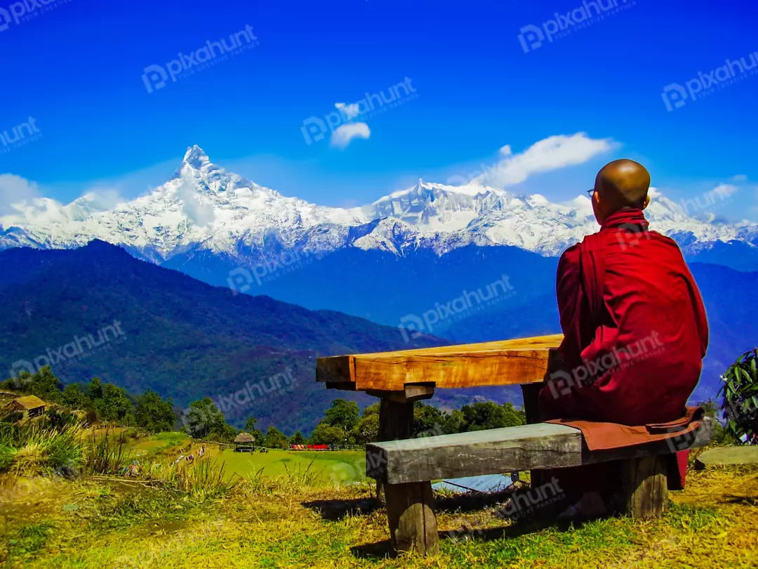 Free Premium Stock Photos The monk is sitting on a bench, with his back to the camera