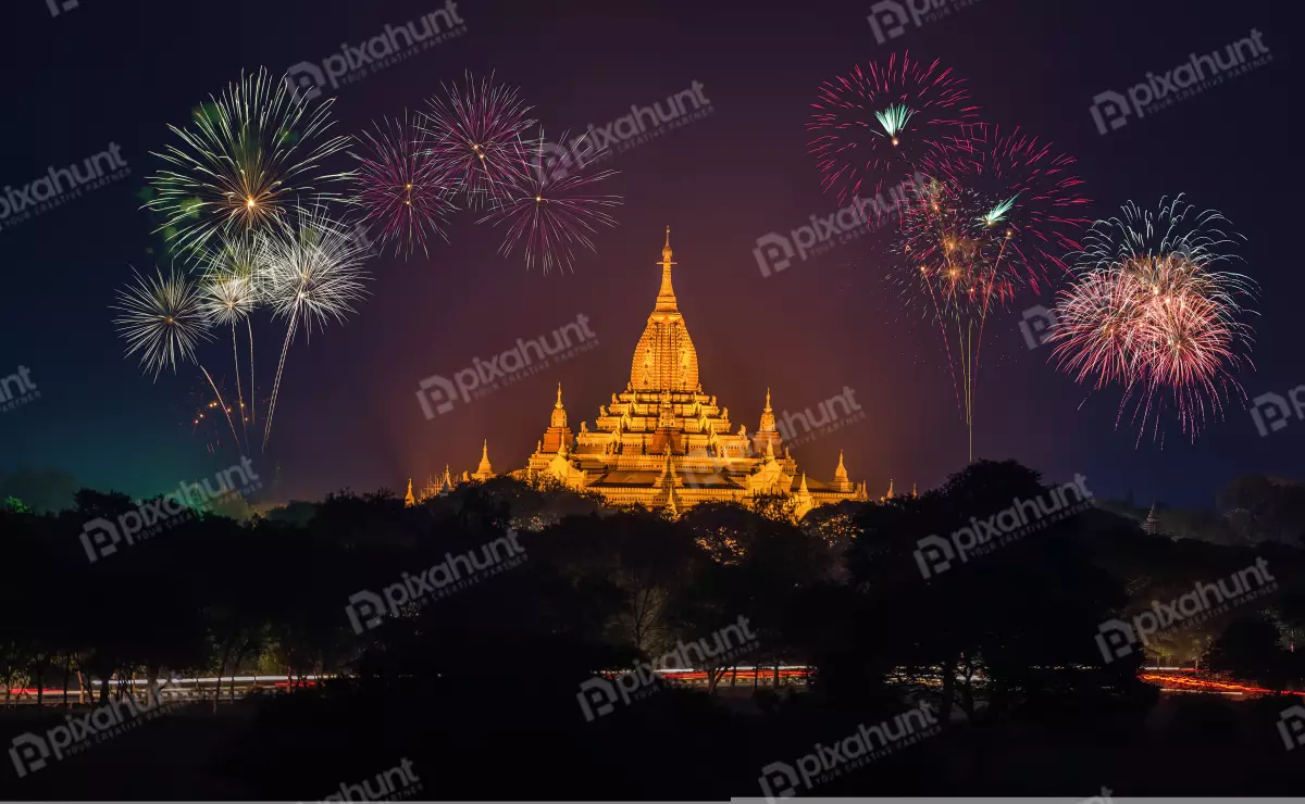 Free Premium Stock Photos The pagoda is lit up by spotlights, and there are fireworks exploding in the background
