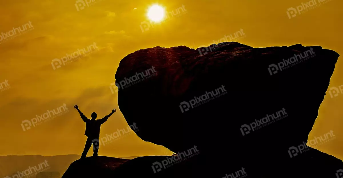 Free Premium Stock Photos The rock is in the center of the photo and the sun is setting behind it and low angle, looking up at a large rock