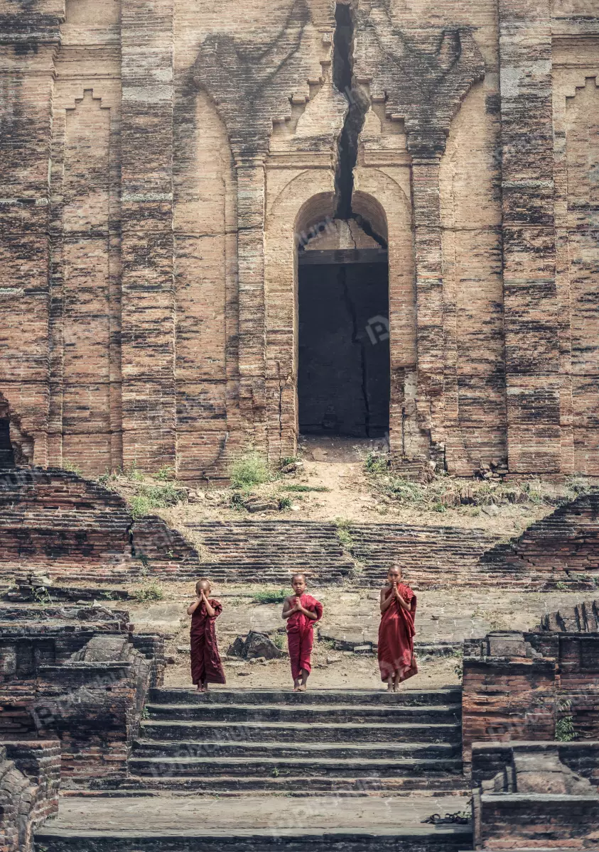 Free Premium Stock Photos Three Buddhist monks in red robes standing in front of a temple
