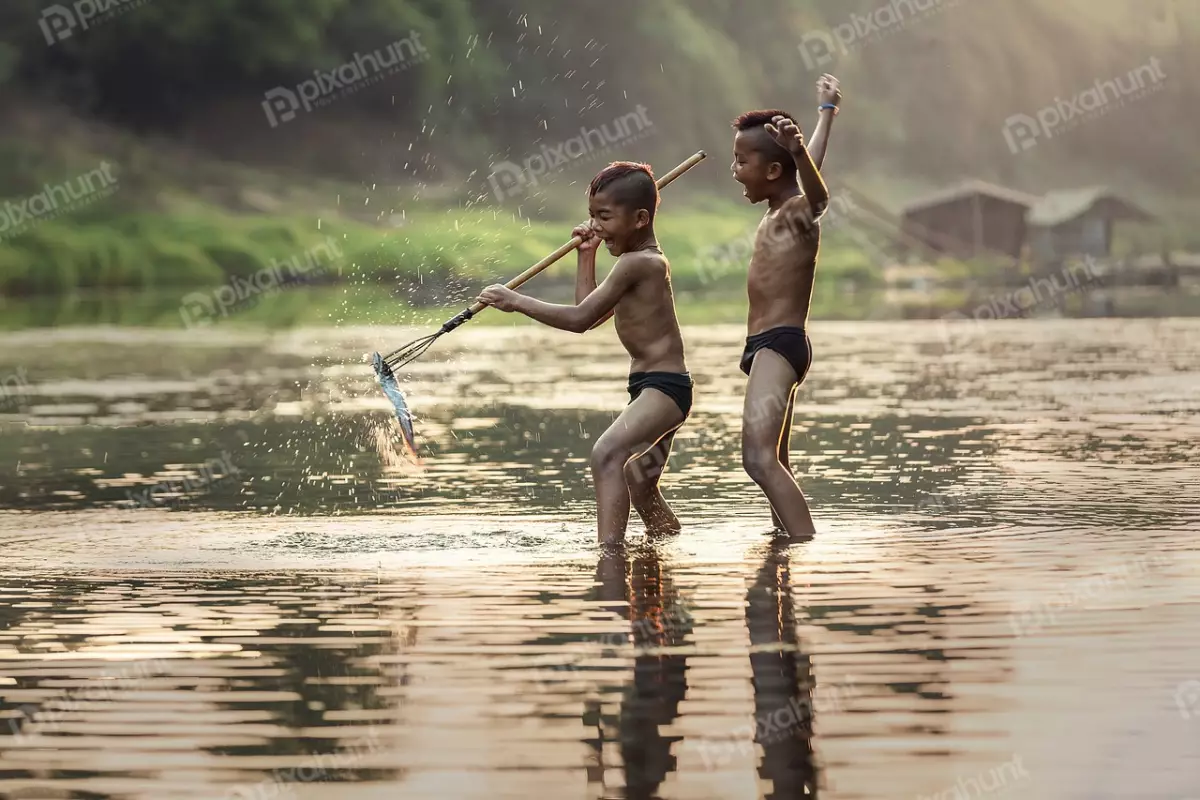 Free Premium Stock Photos Two children boys playing in a river and boys are both smiling and appear to be having a great time