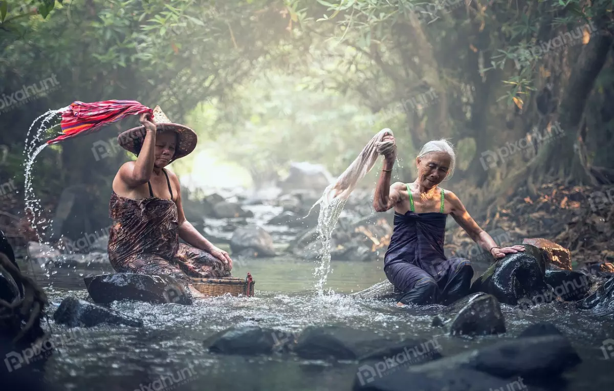 Free Premium Stock Photos Two old women washing clothes in a river