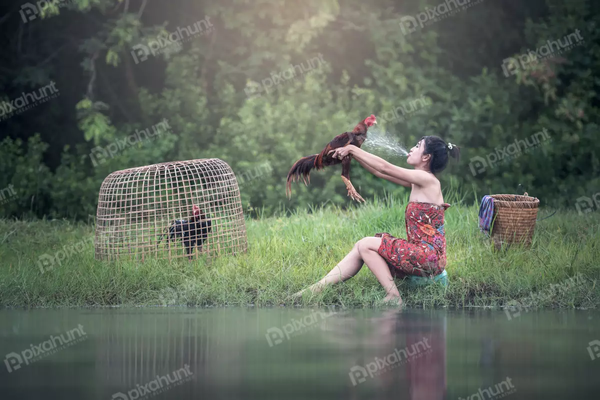 Free Premium Stock Photos Woman in a traditional Vietnamese dress sitting on a rock in a river