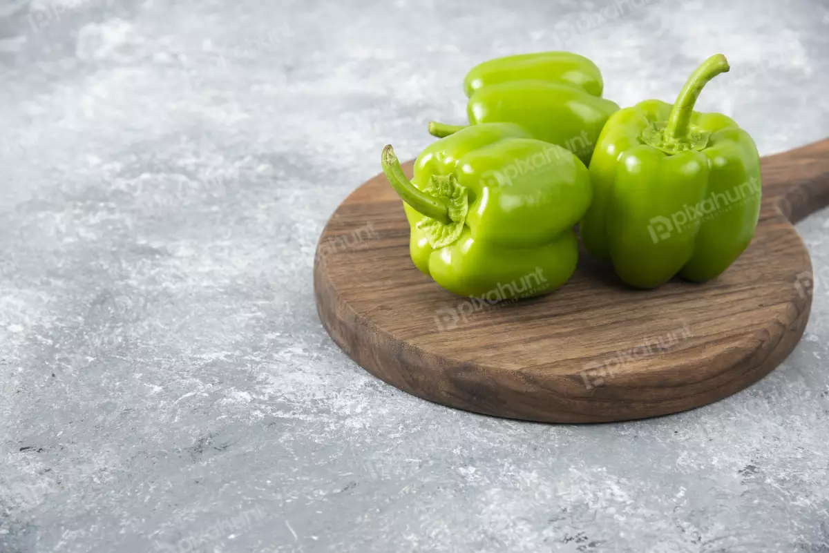 Free Premium Stock Photos Wooden board on green bell peppers | Fresh green bell peppers placed on a wooden round board