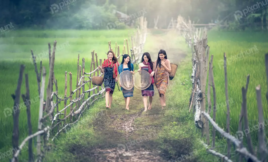 Free Premium Stock Photos Three woman walking in a field and women are wearing traditional clothing and carrying baskets