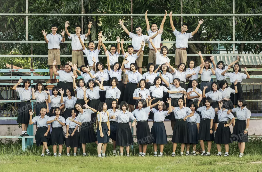 Free Premium Stock Photos A group of students in a school uniform and standing in a staggered formation, with the tallest students in the back and the shortest students in the front