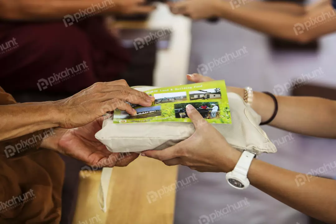 Free Premium Stock Photos A person holding a white envelope with a photo of a building on it