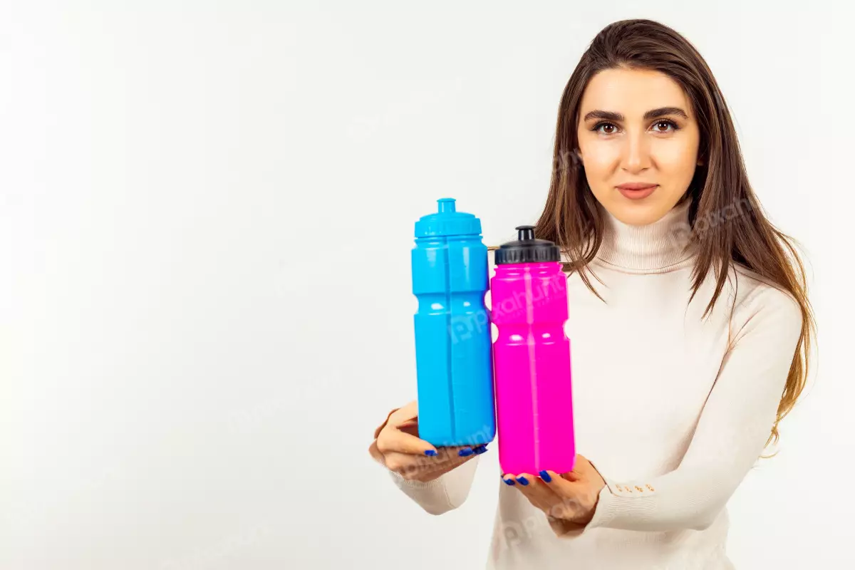 Free Premium Stock Photos Young girl adorable holding two water bottles and looking at the camera on white background