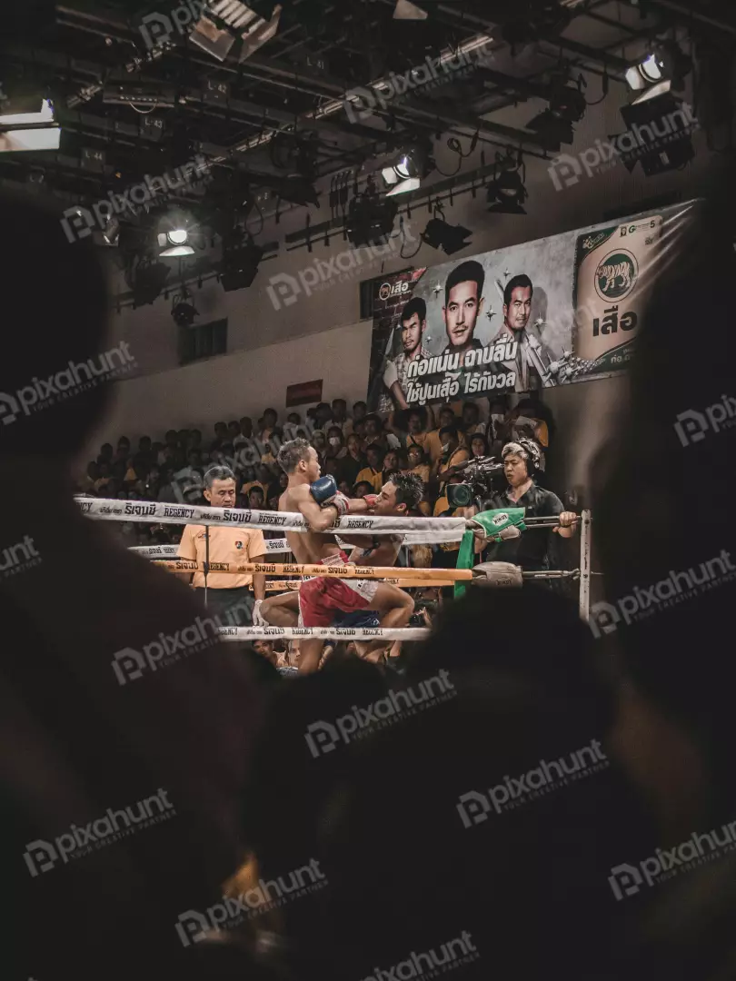 Free Premium Stock Photos A boxing match on two boxers are in the ring and the referee is standing in between them