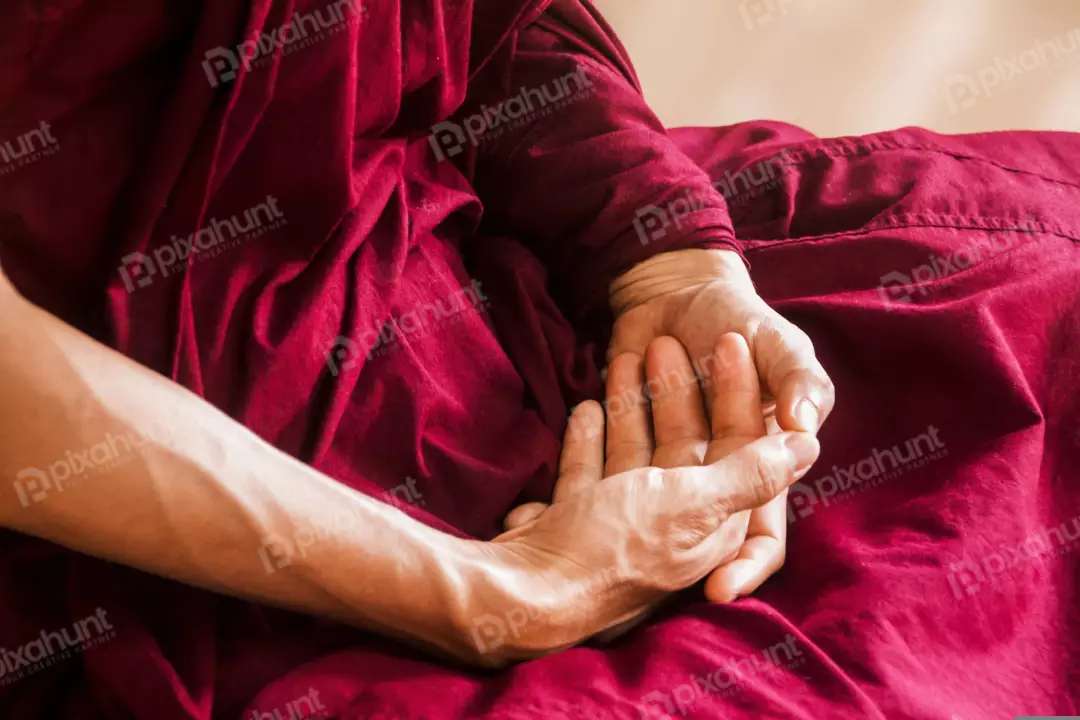 Free Premium Stock Photos A Buddhist in a red robe, sitting in a meditative pose