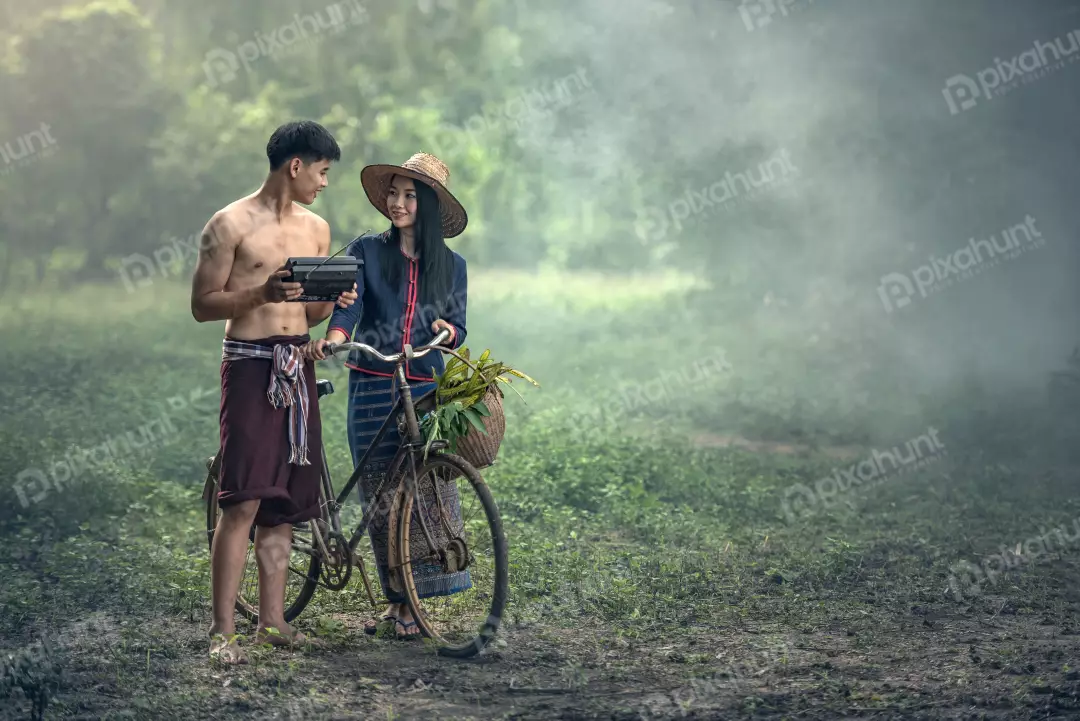 Free Premium Stock Photos A beautiful landscape of a rural area and a couple standing in the middle of a field