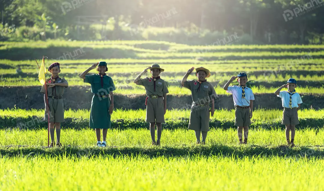 Free Premium Stock Photos A group of six children in a field, dressed in green scout uniforms