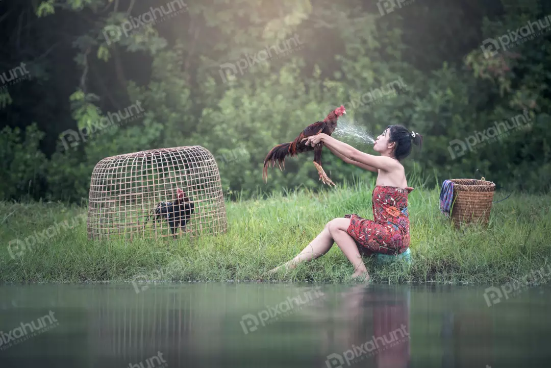 Free Premium Stock Photos Woman in a traditional Vietnamese dress sitting on a rock in a river