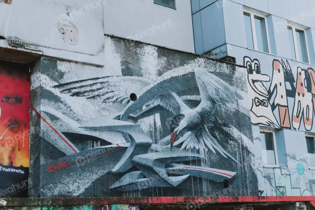 Free Premium Stock Photos looking up at a large graffiti mural on the side of a building