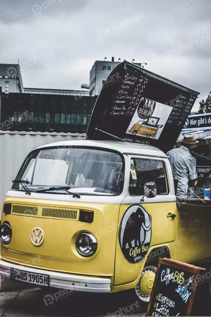 Free Premium Stock Photos a yellow and white Volkswagen bus that has been converted into a coffee shop