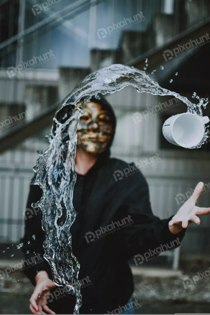 Free Premium Stock Photos looking down on a person in a black hoodie and a tiger mask