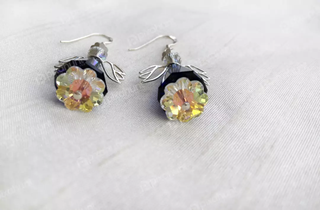 Free Premium Stock Photos The earrings are made of yellow and blue crystals