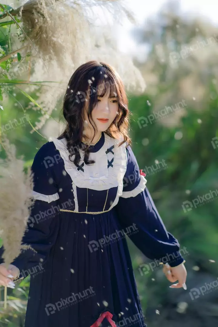 Free Premium Stock Photos A young Girl wearing a beautiful dress is dark blue with white lace trim