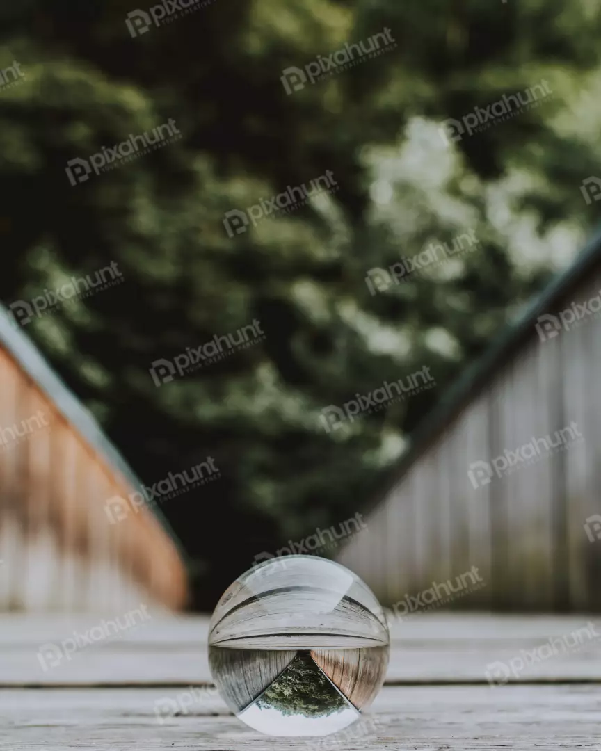 Free Premium Stock Photos a glass ball on a wooden floor