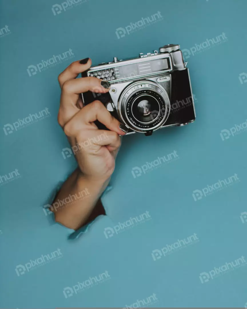 Free Premium Stock Photos a close-up of a hand holding a vintage camera