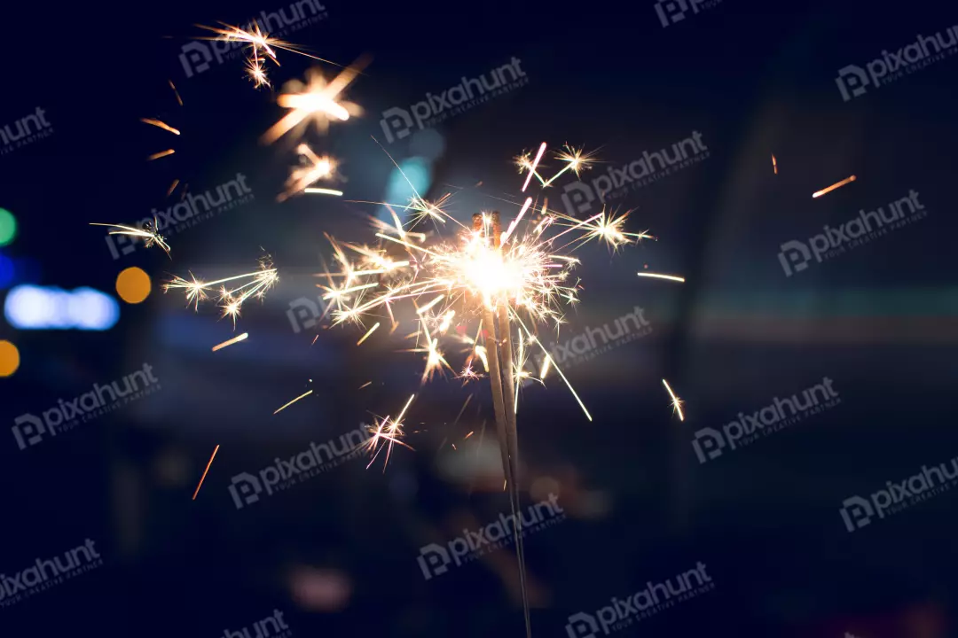 Free Premium Stock Photos a handheld firework that produces a shower of sparks when ignited