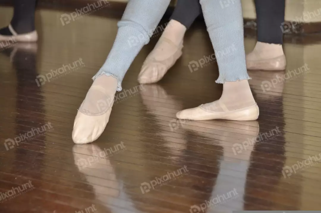 Free Premium Stock Photos A group of ballet dancers standing on a wooden floor from a low angle