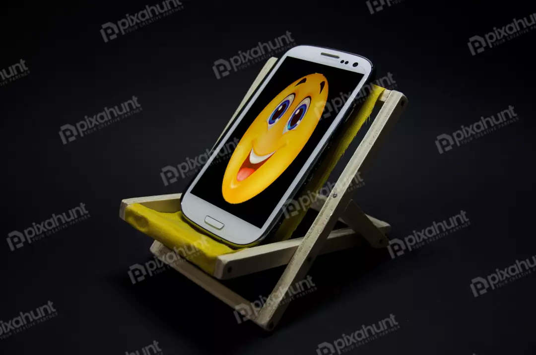 Free Premium Stock Photos A smartphone sitting in a beach chair