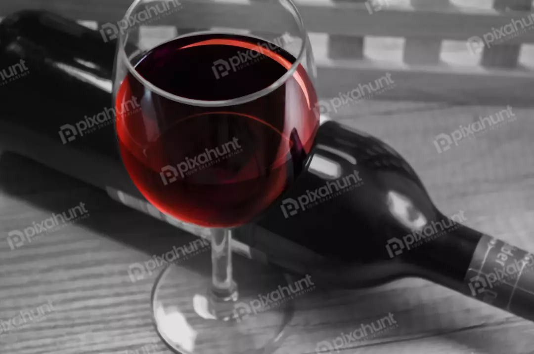 Free Premium Stock Photos A still life of a glass of red wine and a bottle of red wine