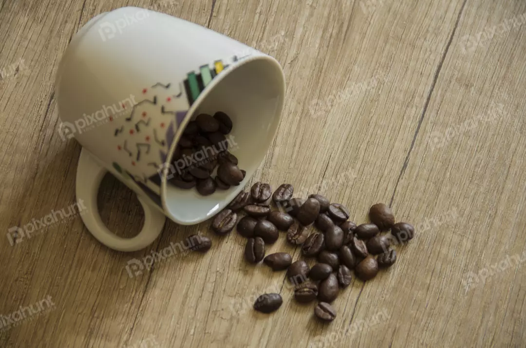 Free Premium Stock Photos A white coffee cup filled with coffee beans