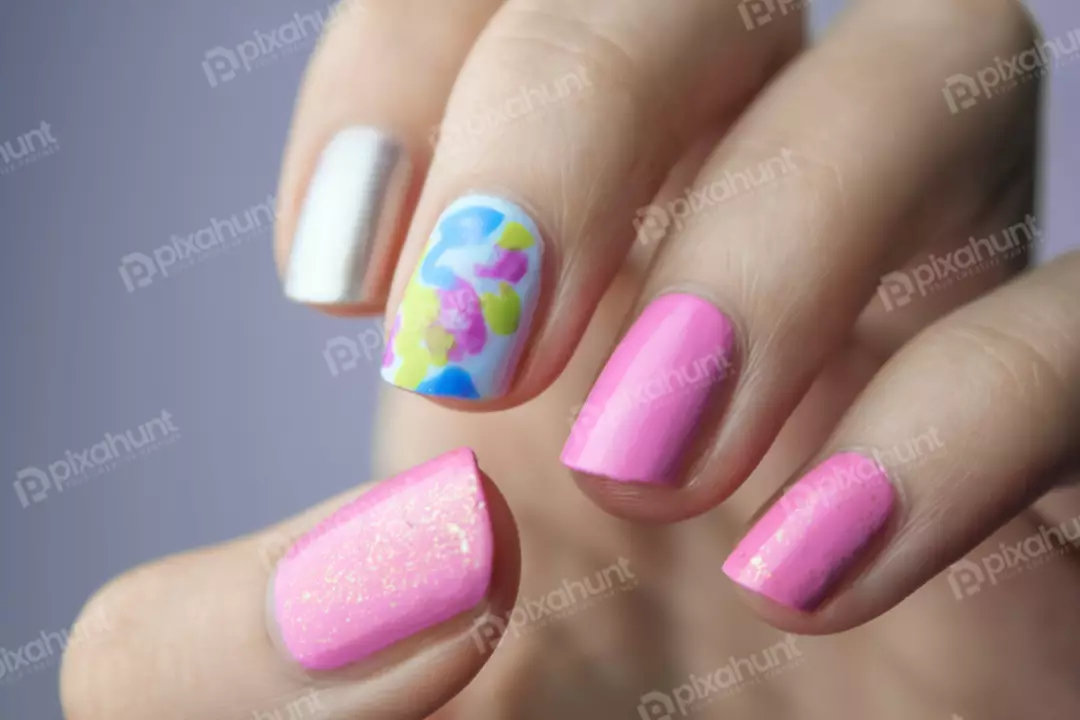 Free Premium Stock Photos A close-up of a hand with a pink and blue manicure