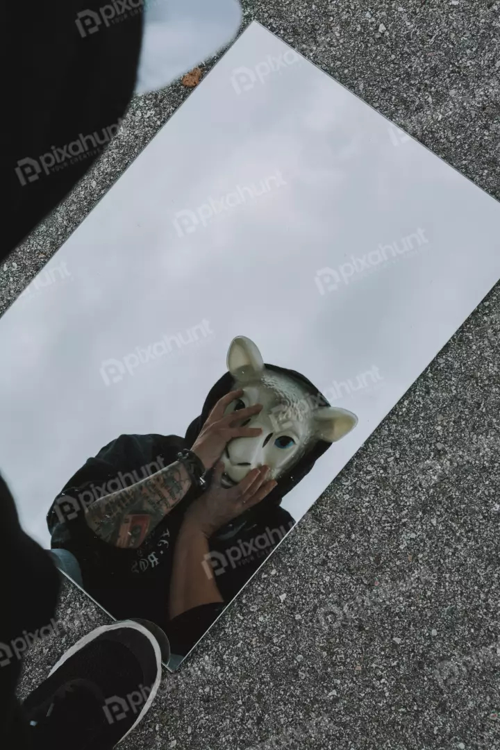 Free Premium Stock Photos looking up at a person wearing a sheep mask