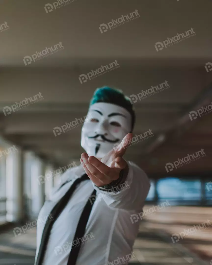 Free Premium Stock Photos a person wearing a Guy Fawkes mask is white with a black mustache and beard